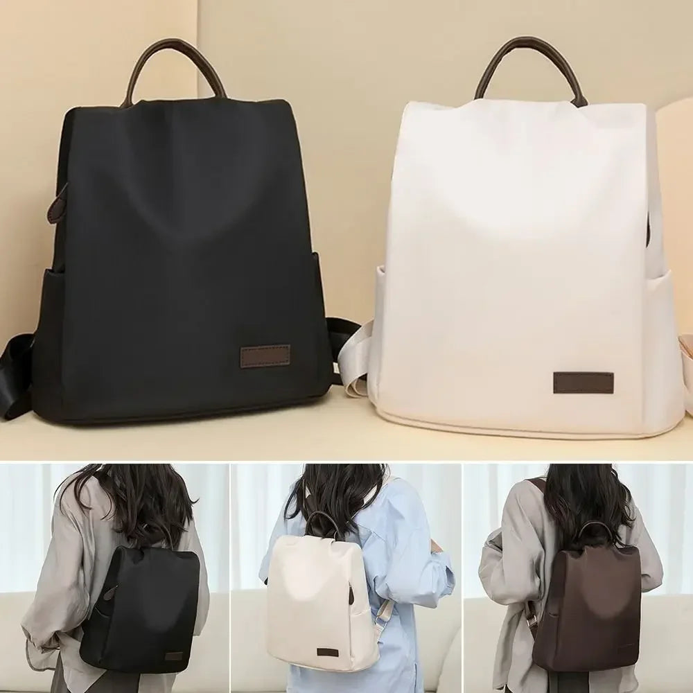Black and white backpacks with a person wearing each color on a neutral background