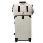 Beige suitcase with a matching duffel bag on a white background
