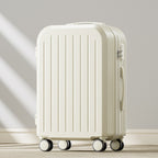 White suitcase with wheels on a light wooden floor and gray wall background